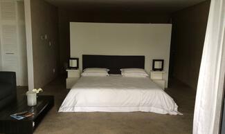 couples enjoy a massage on a king size bed